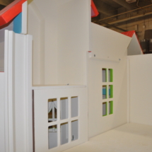 Loft area of a custom indoor playhouse with slides.