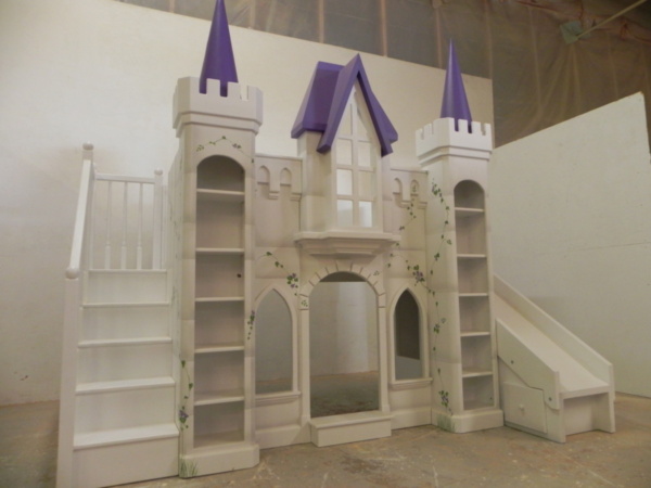 Purple castle bunk bed with spindled staircase.